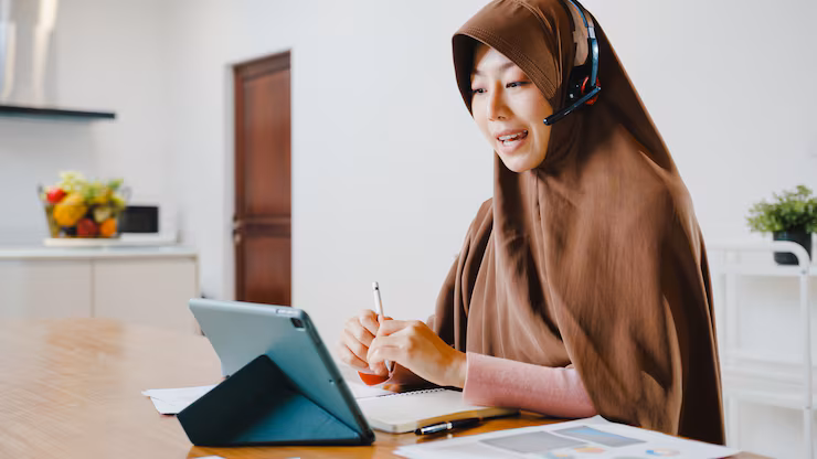 Young Pakistani child during online Naat class on a tablet